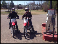 Two dirt bikers stopped at station.